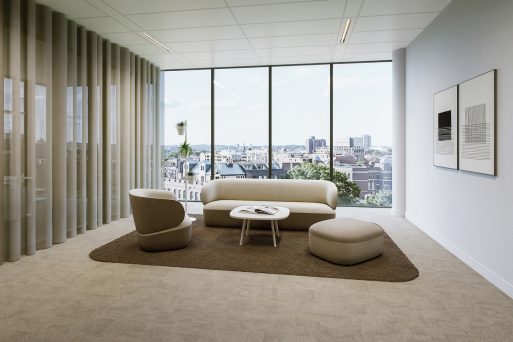 Modern lounge and seating area with a seating arrangement of upholstered furniture, consisting of a sofa, an armchair, and a pouf. The sofa and armchair feature two-tone upholstery, with cream-white seat and back surfaces and beige lower upholstered sections. The pouf is finished in a matching beige tone. The upholstered furniture is arranged around a low, round coffee table with a white tabletop and a light-colored frame and is placed on a brown rectangular rug that visually brings the seating area together.
