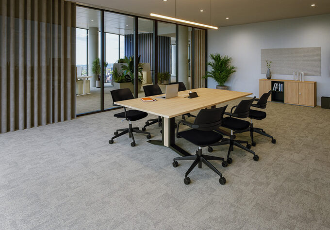 Conference and meeting room with a medium‑sized rectangular table featuring a white tabletop and a white table frame, designed for meetings with multiple participants. Around the table are six white swivel office chairs, three on each long side, equipped with grey upholstered seat cushions and light-colored backrests. Along the walls, there are white storage cabinets, light grey acoustic wall panels, and plants, creating a calm and professional atmosphere. Floor‑to‑ceiling glass surfaces and grey‑beige, semi‑transparent curtains support the bright, open feel of the room.