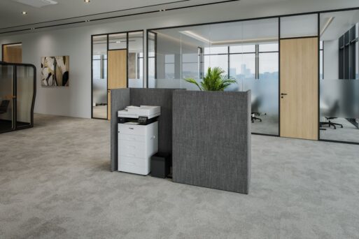 A screened-off printer area in the office featuring an enclosure, a cabinet with hinged doors, a planter, and a wastebasket—the Officebox Print from the neudoerfler Contrast S Collection.