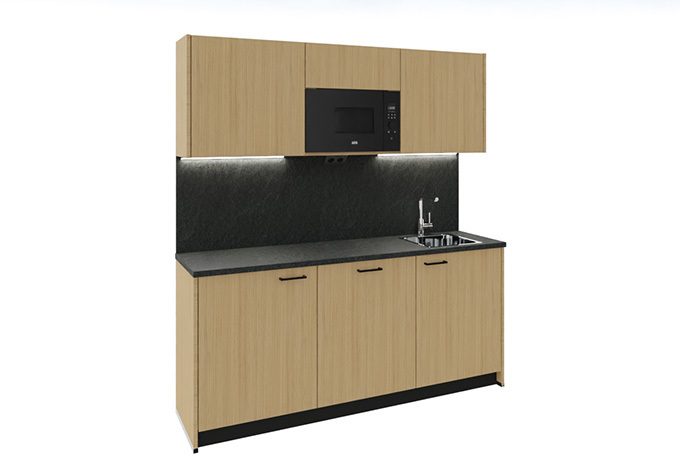 A kitchenette with an oak-look finish, a black countertop, and stylish accents, serving as a modern office kitchenette.