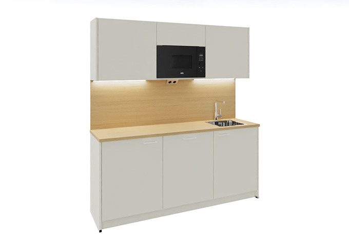 A white kitchenette with an oak countertop, serving as a modern office kitchenette.